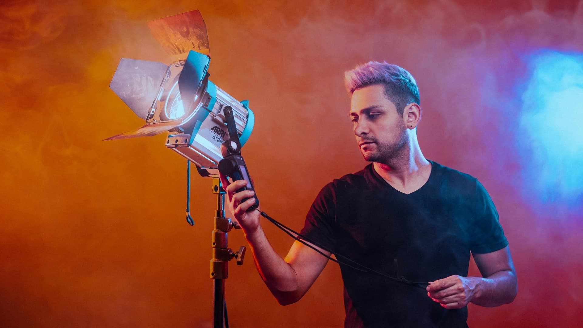 A lighting technician preparing a lecture recording set