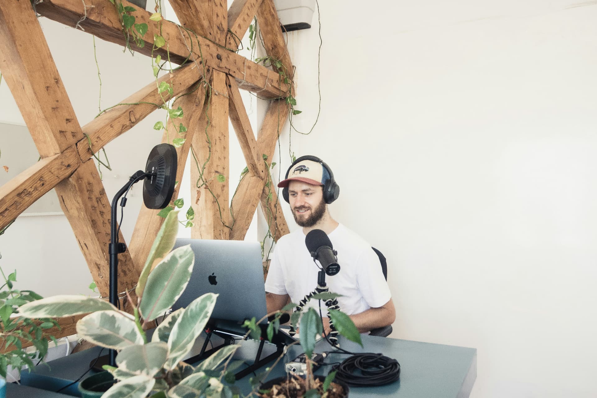 A podcaster recording an episode at a desk microphone